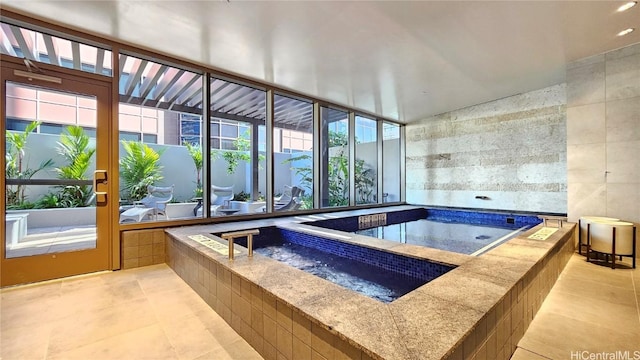 view of pool with an indoor hot tub