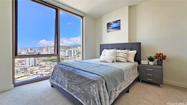 bedroom with light colored carpet and floor to ceiling windows