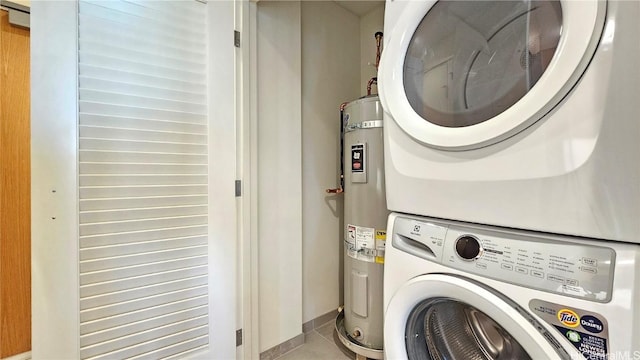 laundry room featuring stacked washing maching and dryer and secured water heater