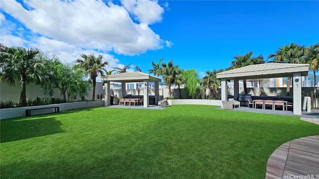 view of yard with a gazebo and exterior bar