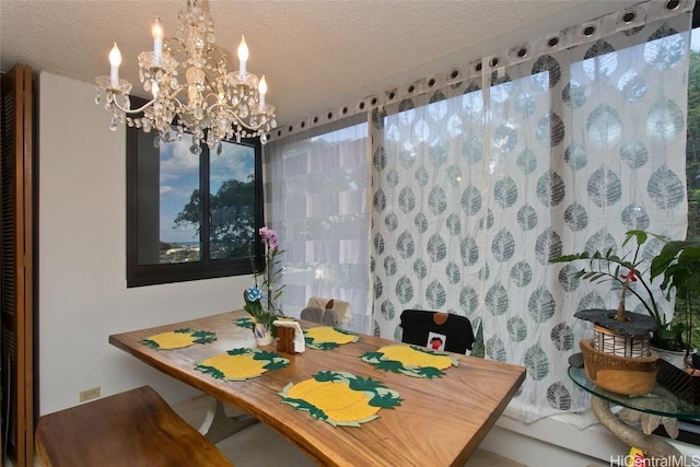 dining room featuring an inviting chandelier and a textured ceiling