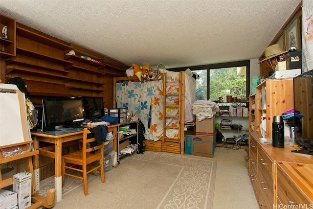 carpeted home office with a textured ceiling