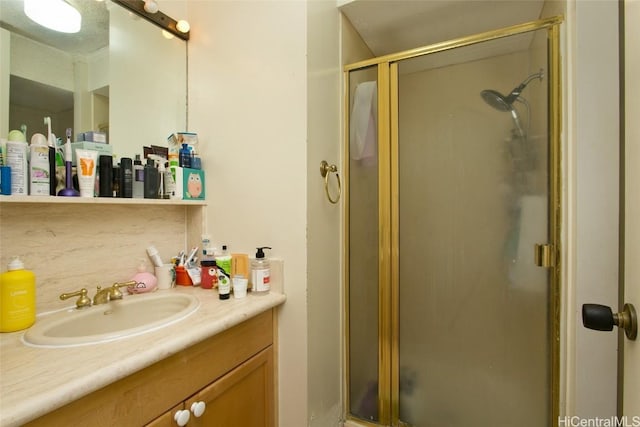 bathroom with vanity and a shower with shower door