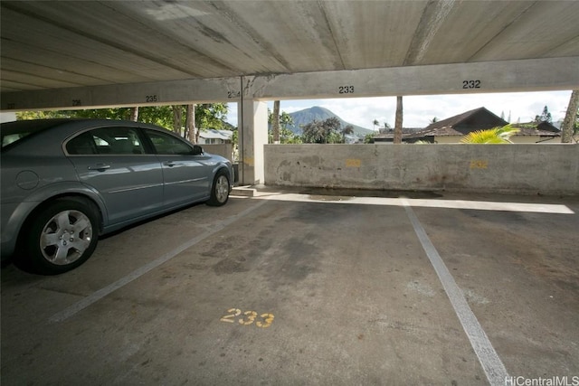 view of car parking with a carport and a mountain view