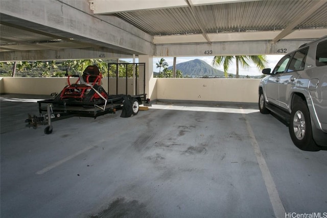 garage featuring a carport and a mountain view