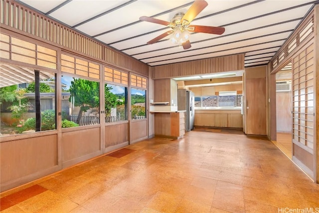 unfurnished sunroom featuring ceiling fan