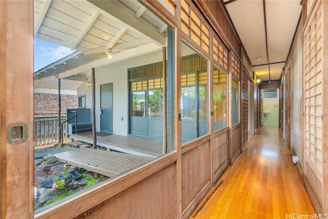 unfurnished sunroom featuring lofted ceiling with beams