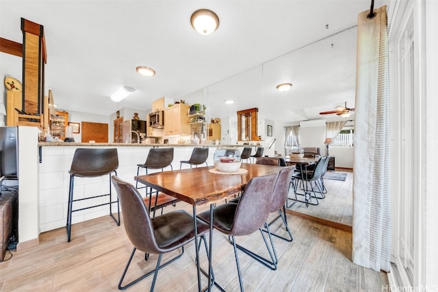 dining room with light wood-style floors and ceiling fan