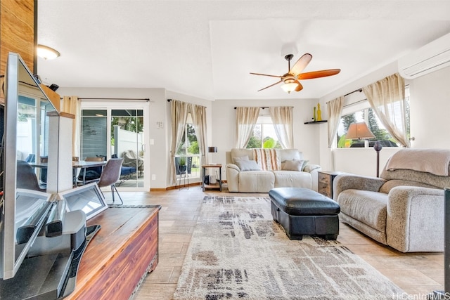 living area featuring ceiling fan, a wall mounted air conditioner, and baseboards