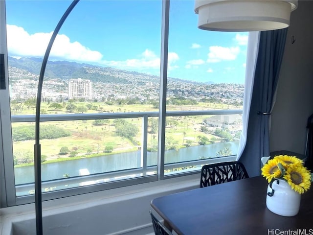 dining space featuring a water and mountain view