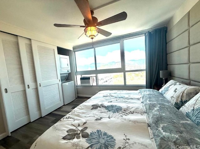 bedroom with stacked washer / drying machine, dark wood-type flooring, ceiling fan, and cooling unit