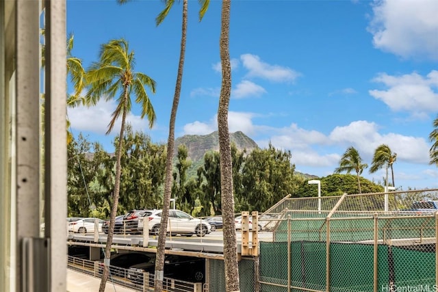 exterior space featuring fence and a mountain view