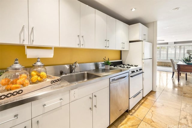 kitchen with white cabinetry, a sink, white range with gas cooktop, and stainless steel dishwasher