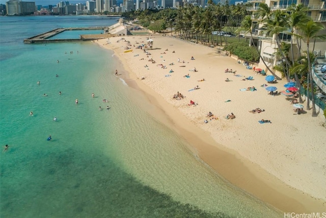 bird's eye view featuring a view of city, a water view, and a beach view