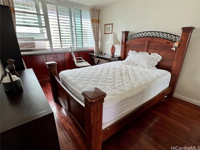 bedroom with dark hardwood / wood-style floors