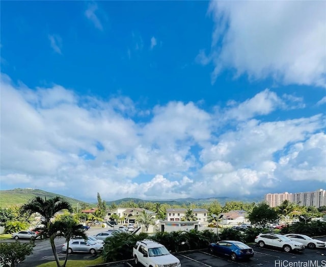 view of vehicle parking with a mountain view