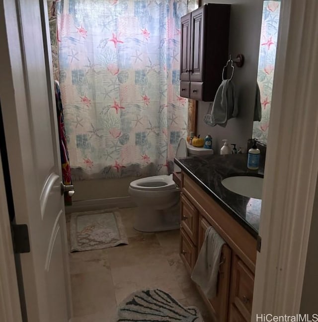 full bathroom featuring shower / bath combo, vanity, and toilet