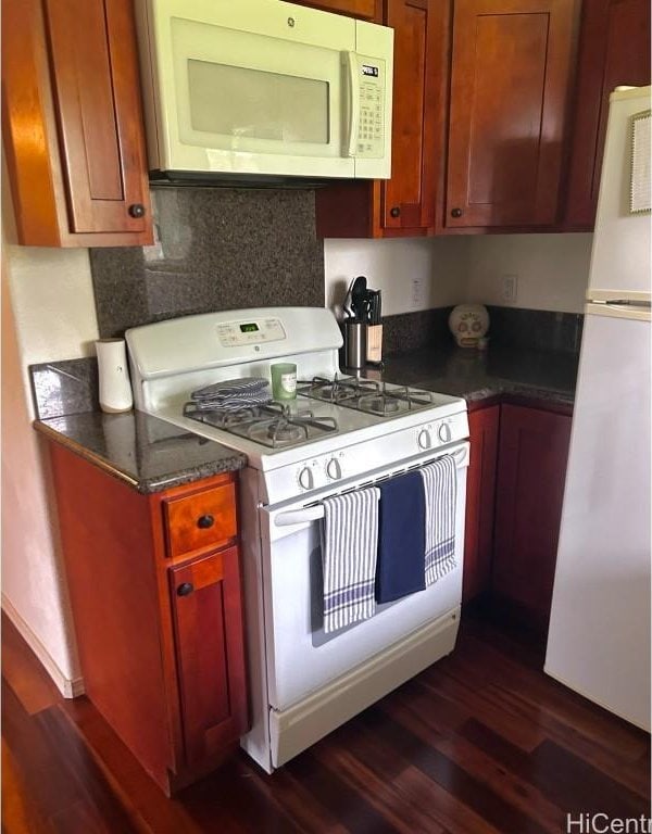 kitchen with white appliances, dark hardwood / wood-style flooring, and decorative backsplash