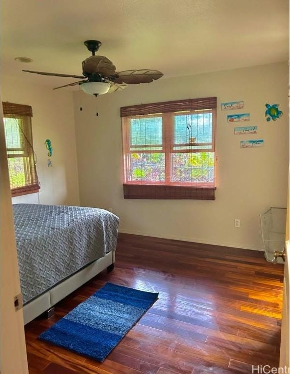 bedroom with dark hardwood / wood-style floors and ceiling fan