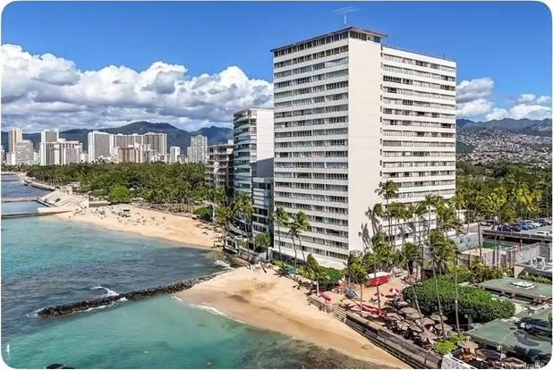 view of property featuring a city view, a water view, and a beach view