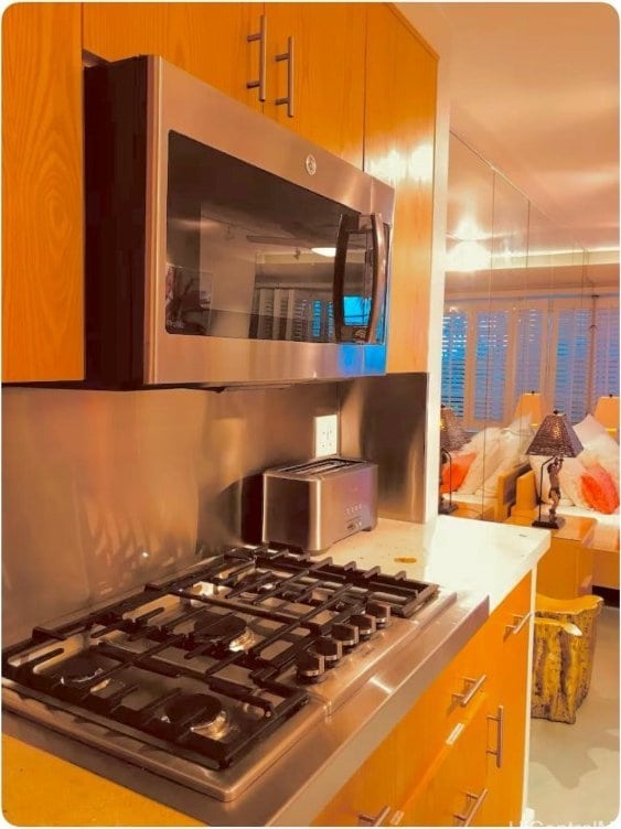 kitchen with brown cabinetry, appliances with stainless steel finishes, and light countertops