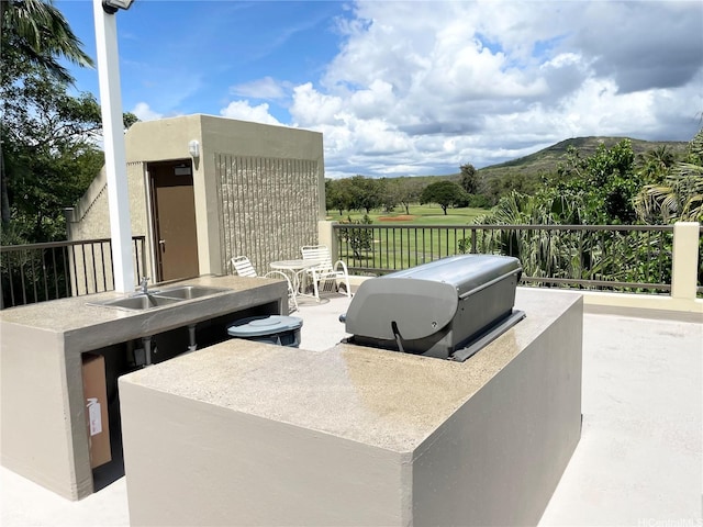 3050 Ala Poha Pl Unit W2, Honolulu, HI 96818 - view of patio with exterior kitchen and a mountain view