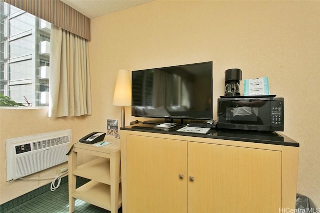 office featuring a wealth of natural light, tile patterned floors, and a wall mounted AC