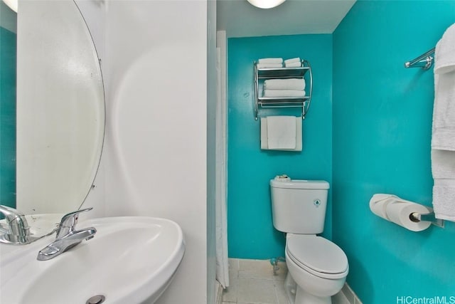 bathroom with sink, tile patterned floors, and toilet