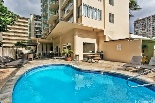 view of swimming pool featuring a patio area