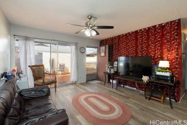 living room featuring hardwood / wood-style floors and ceiling fan