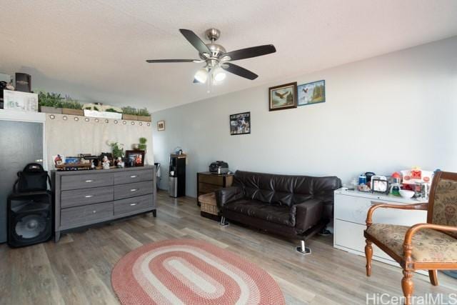 living room featuring ceiling fan and light wood-type flooring