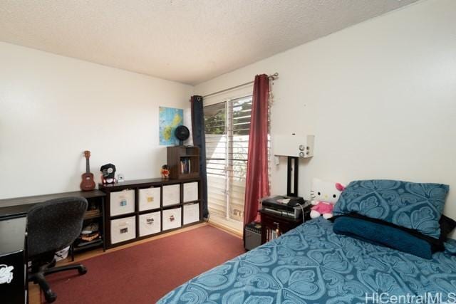 bedroom featuring a textured ceiling and carpet