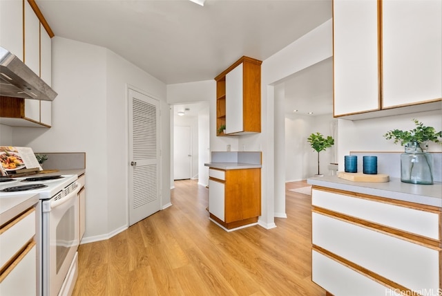 kitchen with white cabinetry, white electric range oven, and light hardwood / wood-style floors