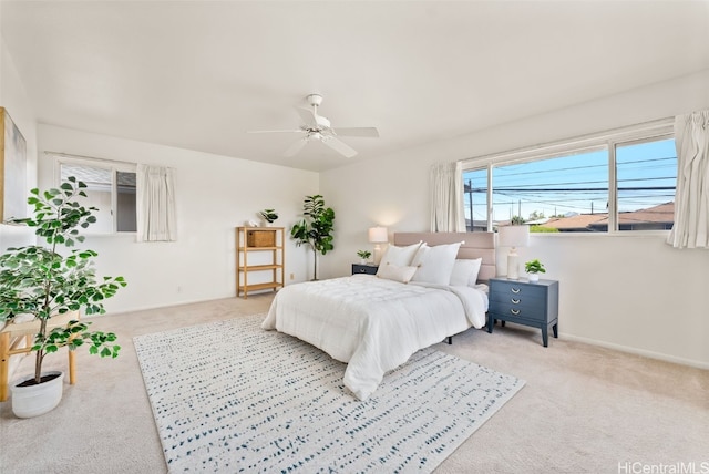 bedroom with ceiling fan and light colored carpet