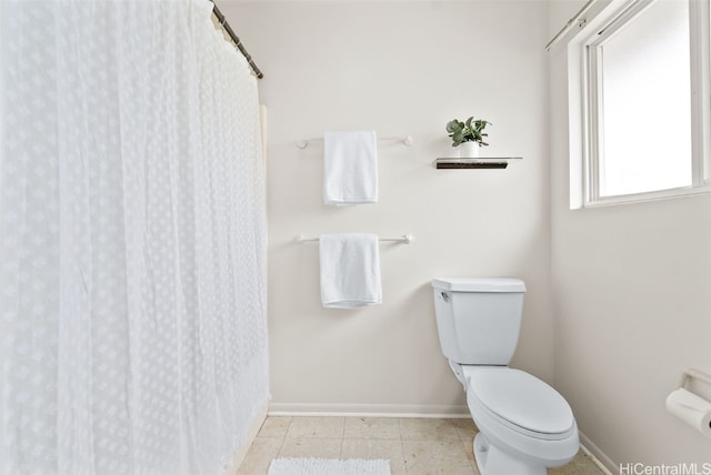 bathroom featuring tile patterned flooring and toilet