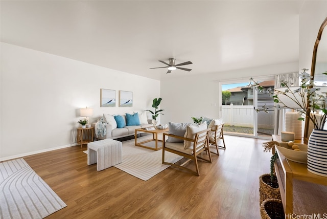 living room with wood-type flooring and ceiling fan