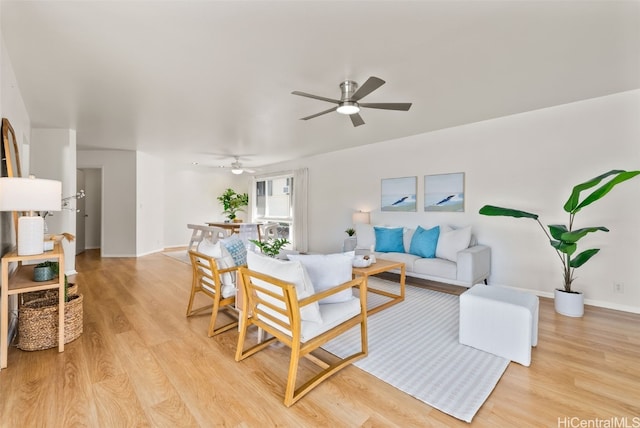 living room featuring ceiling fan and light hardwood / wood-style floors