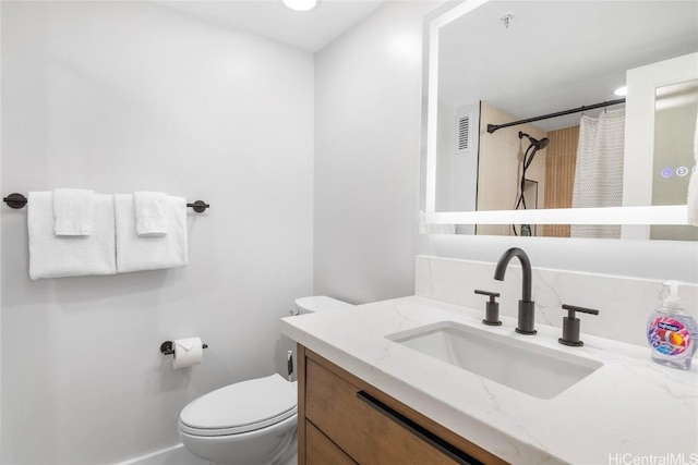 bathroom with a shower with curtain, vanity, and toilet