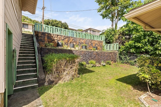 view of yard with stairs and fence