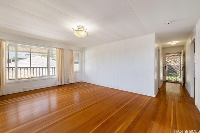 empty room with hardwood / wood-style flooring