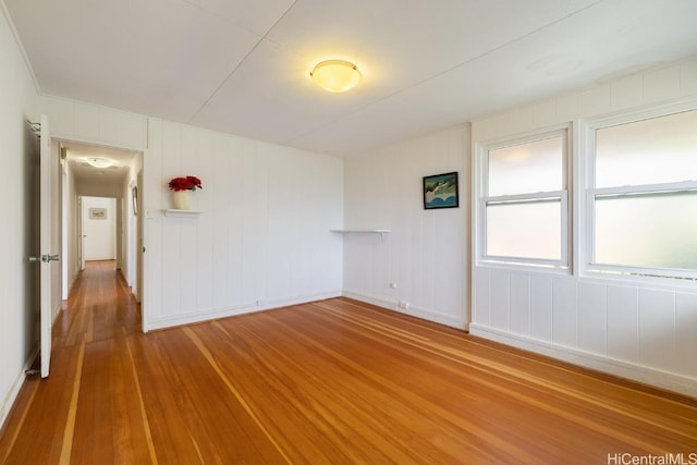 unfurnished room with wood-type flooring