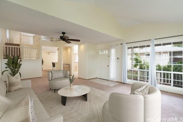 carpeted living room with ceiling fan and lofted ceiling