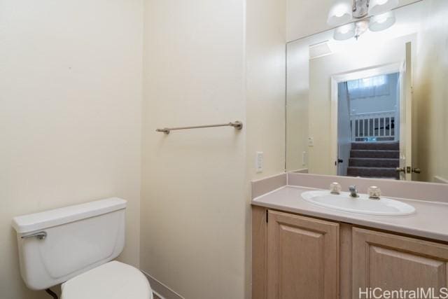 bathroom featuring vanity and toilet