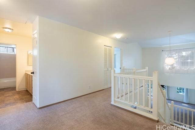 hall featuring light carpet