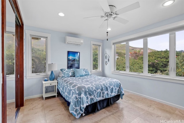 bedroom with ceiling fan and an AC wall unit