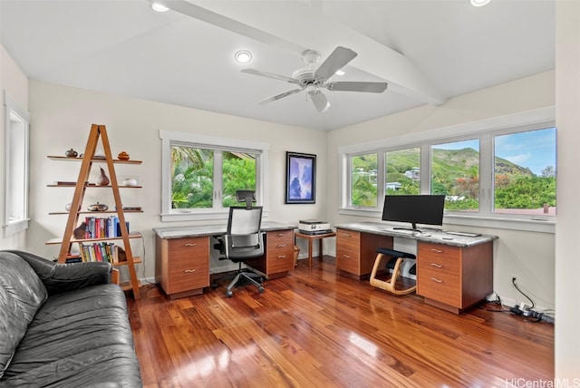 home office featuring vaulted ceiling with beams, dark hardwood / wood-style floors, a wealth of natural light, and ceiling fan