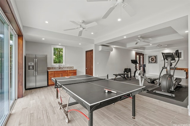 314 Lapa Pl, Kailua, HI 96734 - playroom featuring a wall mounted AC, a tray ceiling, ceiling fan, recessed lighting, and light wood finished floors