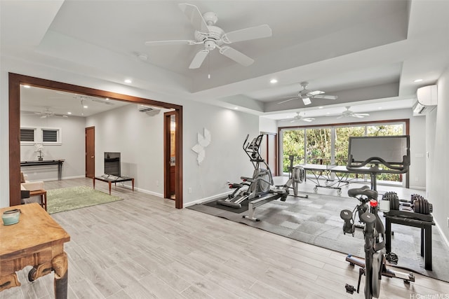 314 Lapa Pl, Kailua, HI 96734 - exercise area featuring a tray ceiling, a ceiling fan, a wall mounted air conditioner, recessed lighting, and light wood finished floors