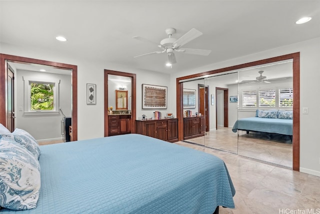 bedroom with ceiling fan, connected bathroom, a closet, and multiple windows