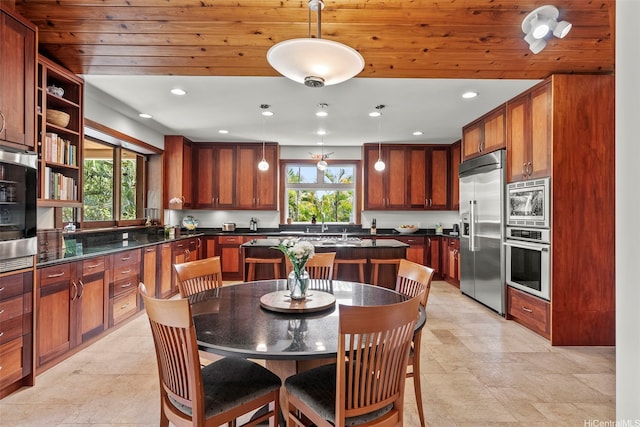 314 Lapa Pl, Kailua, HI 96734 - kitchen featuring built in appliances, dark countertops, hanging light fixtures, wooden ceiling, and brown cabinetry